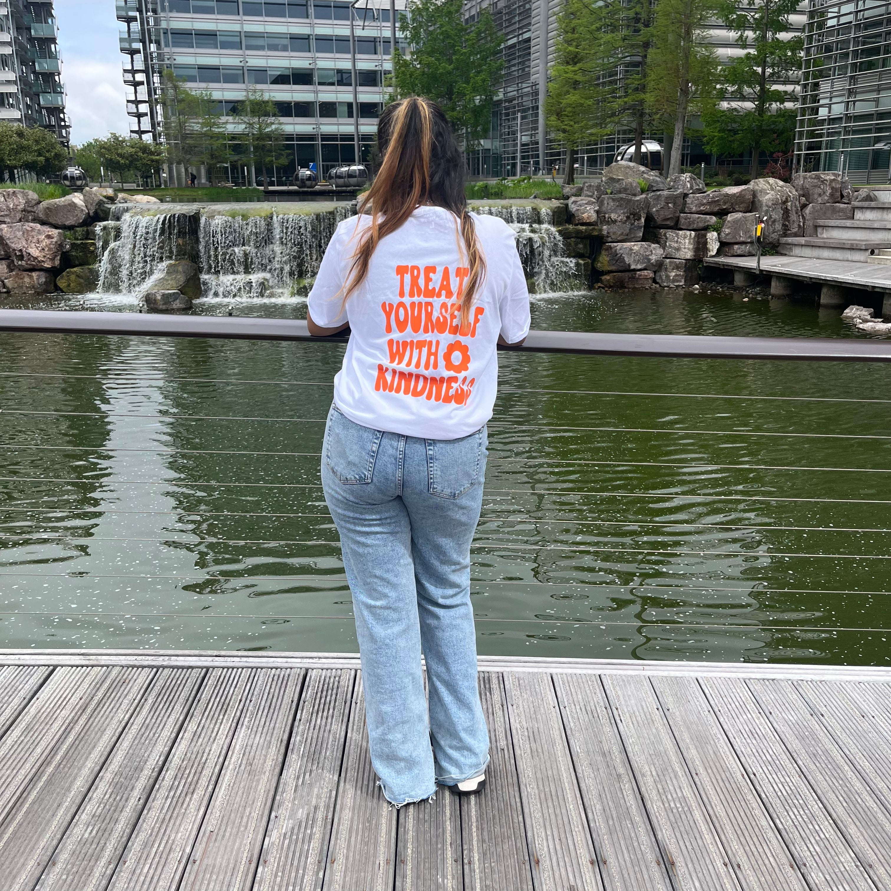 Treat yourself with kindness white T-shirt with orange text