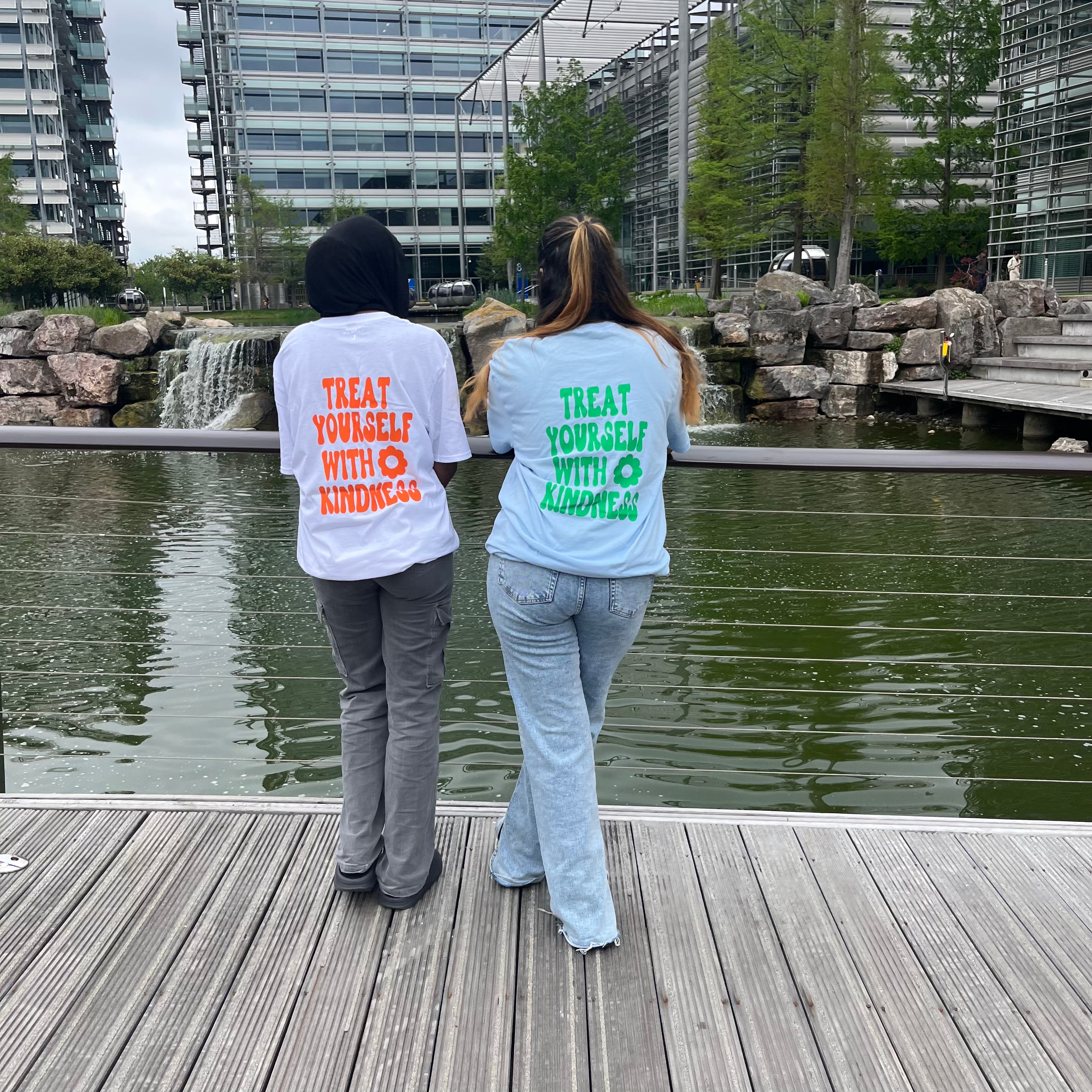 Treat yourself with kindness white T-shirt with orange text